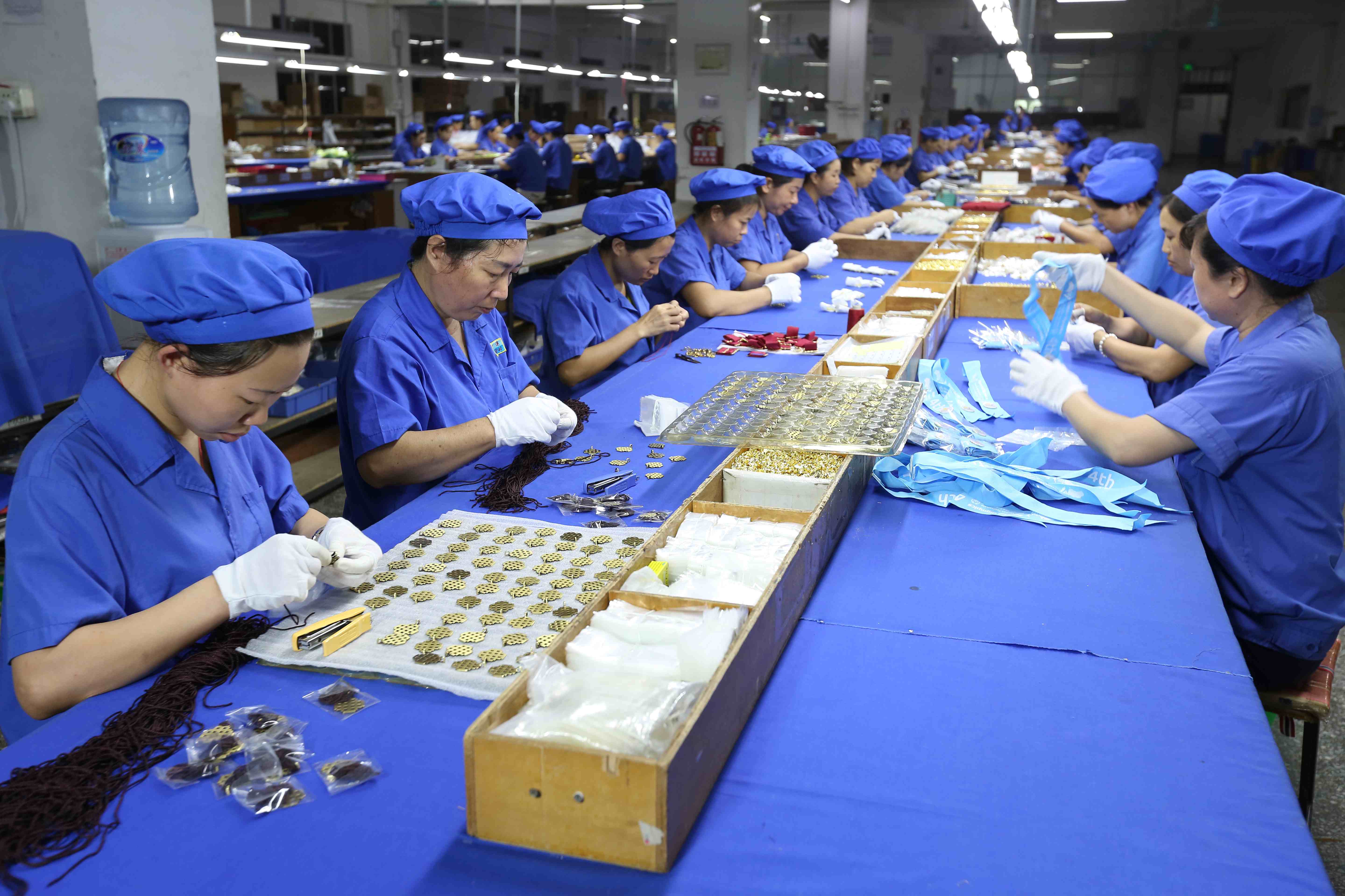 Happy gift packaging workshop - Dongguan happy gift packaging workshop displaying automated gift box assembly line with workers operating precision wrapping machines in a modern industrial setting